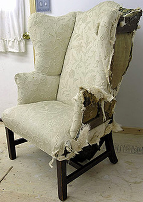 Wing chair with loose frame and old upholstery