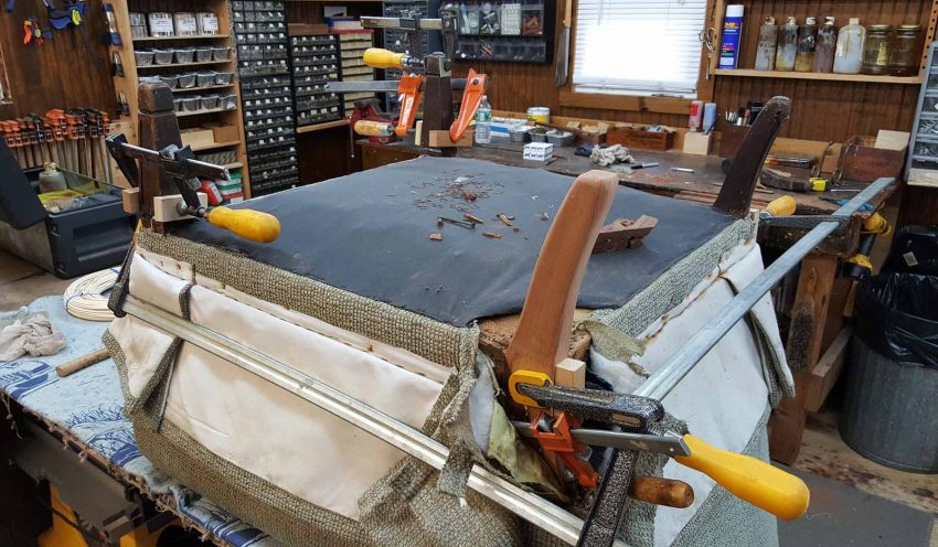 Upholstered chair with new leg glued and clamped