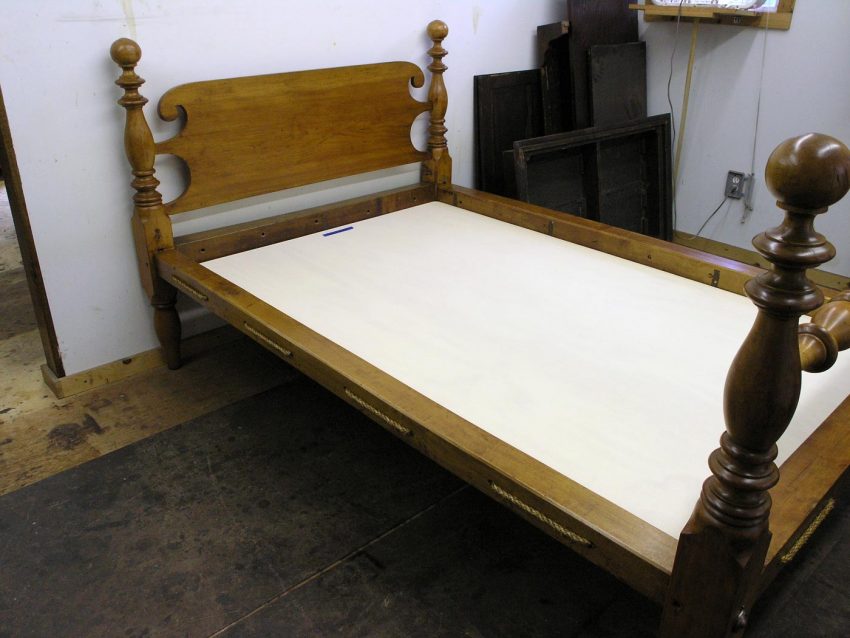 Antique cannonball bed with rope on rails