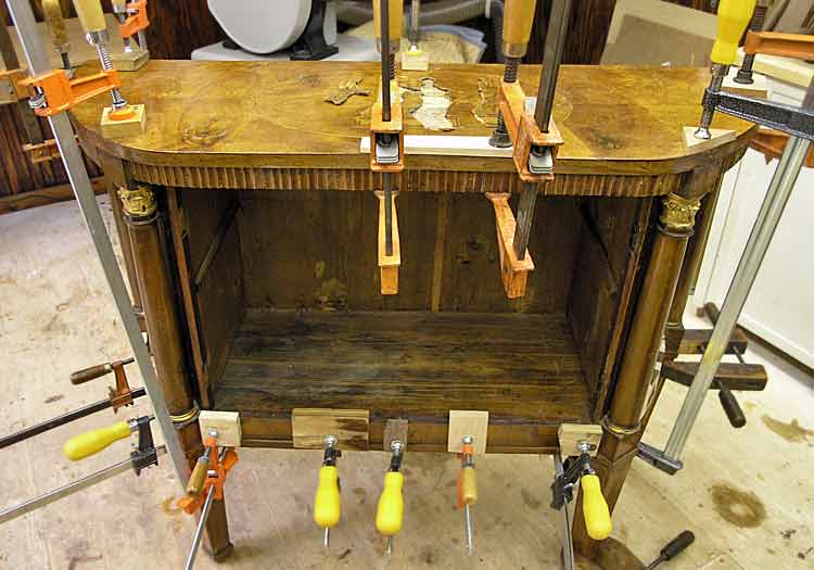 Repairing furniture with glue and clamps